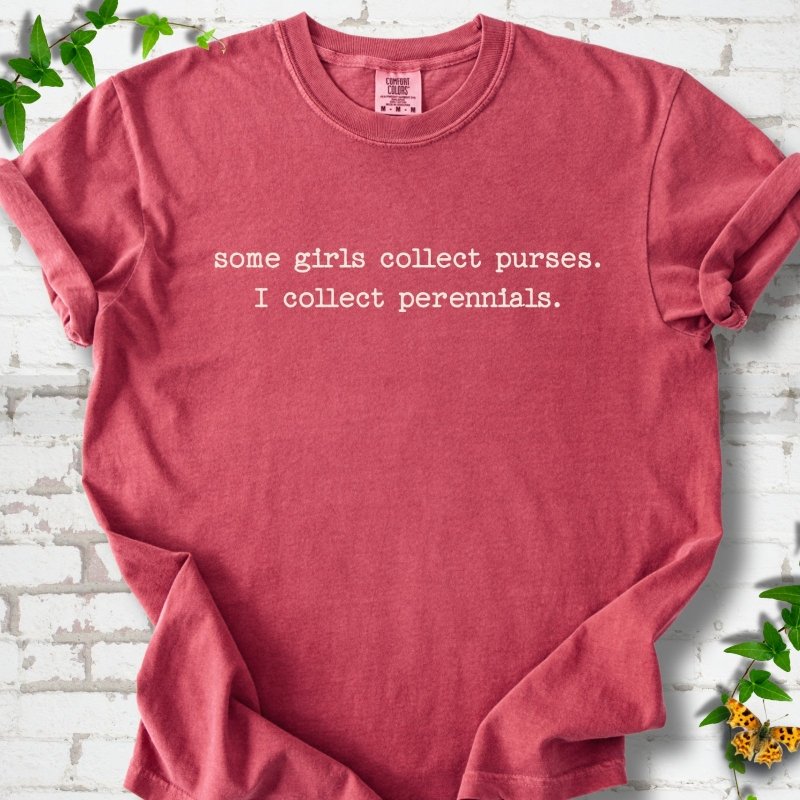 Crimson Comfort Colors® T-shirt front mockup featuring Cream typewriter-style text reads “some girls collect purses. I collect perennials.” in a centered two-line layout.