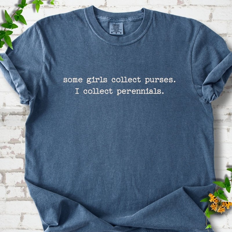 Denim Comfort Colors® T-shirt front mockup featuring Cream typewriter-style text reads “some girls collect purses. I collect perennials.” in a centered two-line layout.