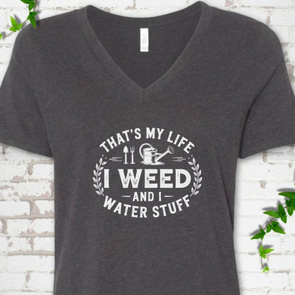 Dark Grey Heather Bella Canvas® V-neck T-shirt flat lay featuring That's My Life I Weed and I Water Stuff text with a watering can and garden tools.
