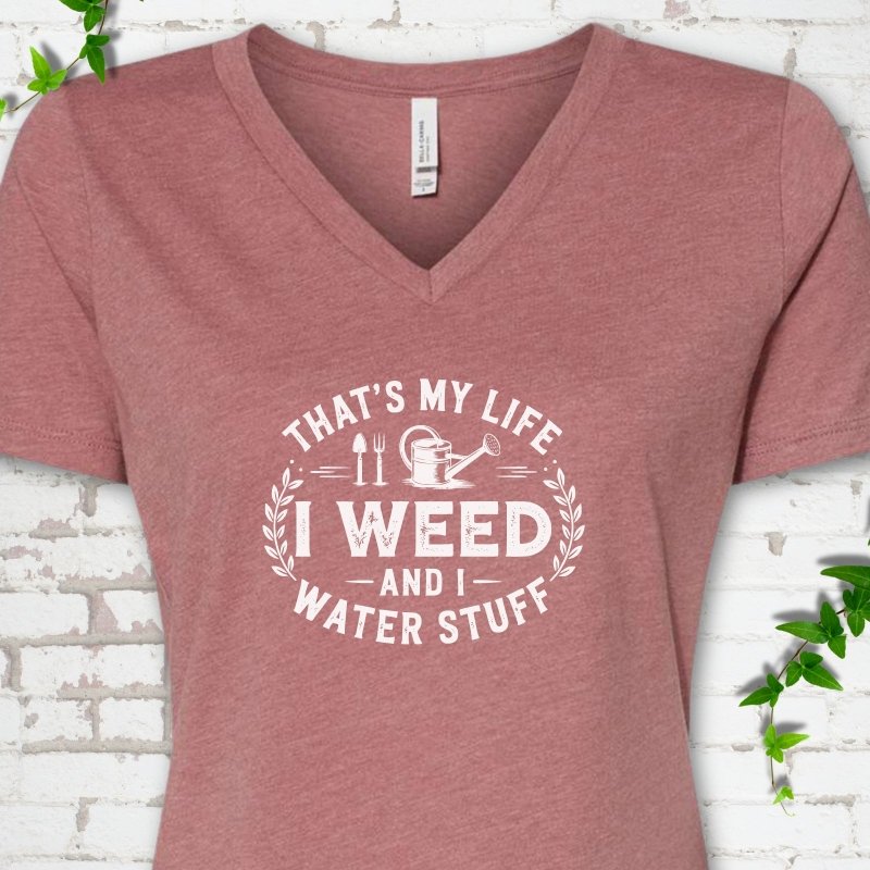 Heather Mauve Bella Canvas® V-neck T-shirt flat lay featuring That's My Life I Weed and I Water Stuff text with a watering can and garden tools.