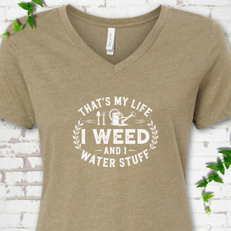 Heather Olive Bella Canvas® V-neck T-shirt flat lay featuring That's My Life I Weed and I Water Stuff text with a watering can and garden tools.