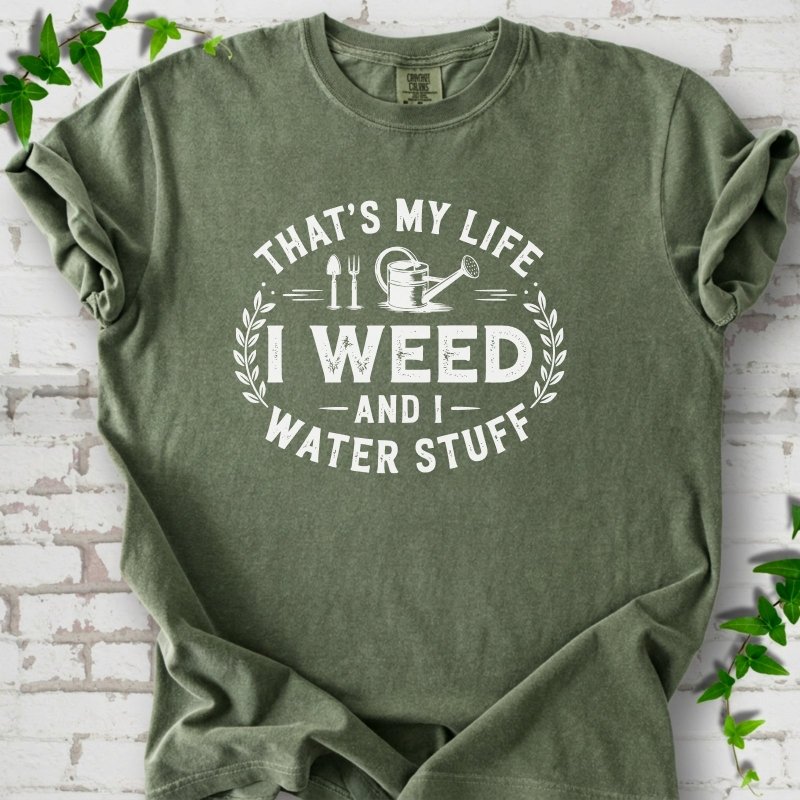 Moss Comfort Colors® T-shirt flat lay featuring That's My Life I Weed and I Water Stuff text with a watering can and garden tools.