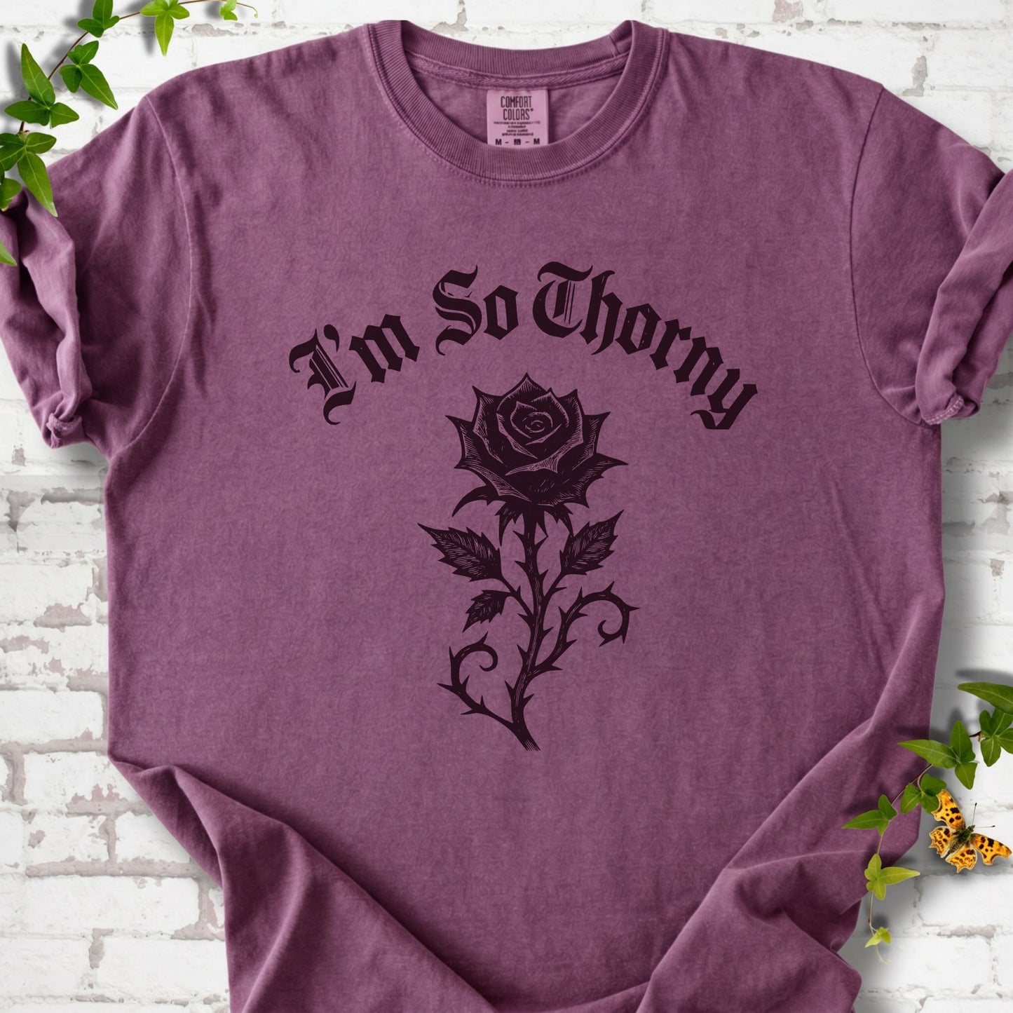 Berry Comfort Colors® T-shirt flat lay with a distressed Gothic blackletter I'm So Thorny rose design.