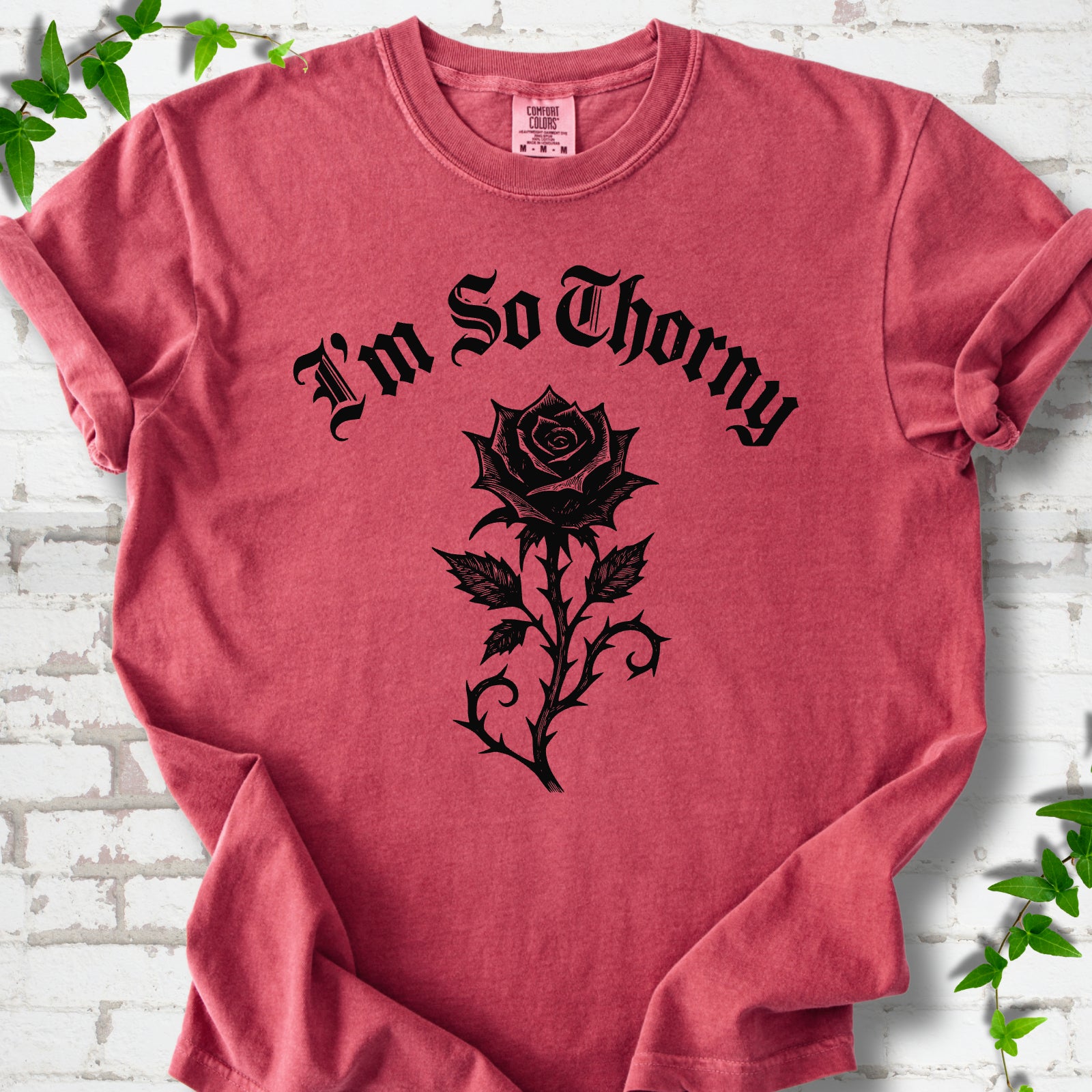 Crimson Comfort Colors® T-shirt flat lay with a distressed Gothic blackletter I'm So Thorny rose design.