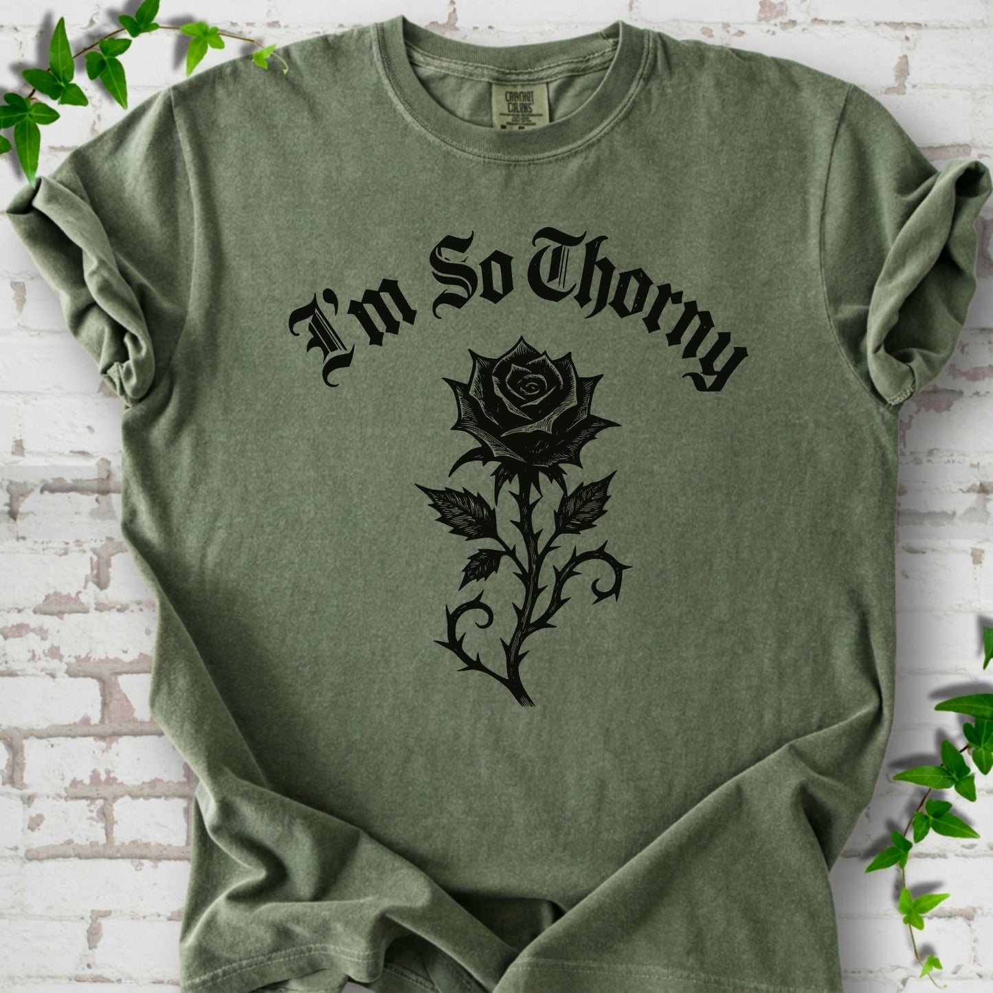 Moss Comfort Colors® T-shirt flat lay with a distressed Gothic blackletter I'm So Thorny rose design.