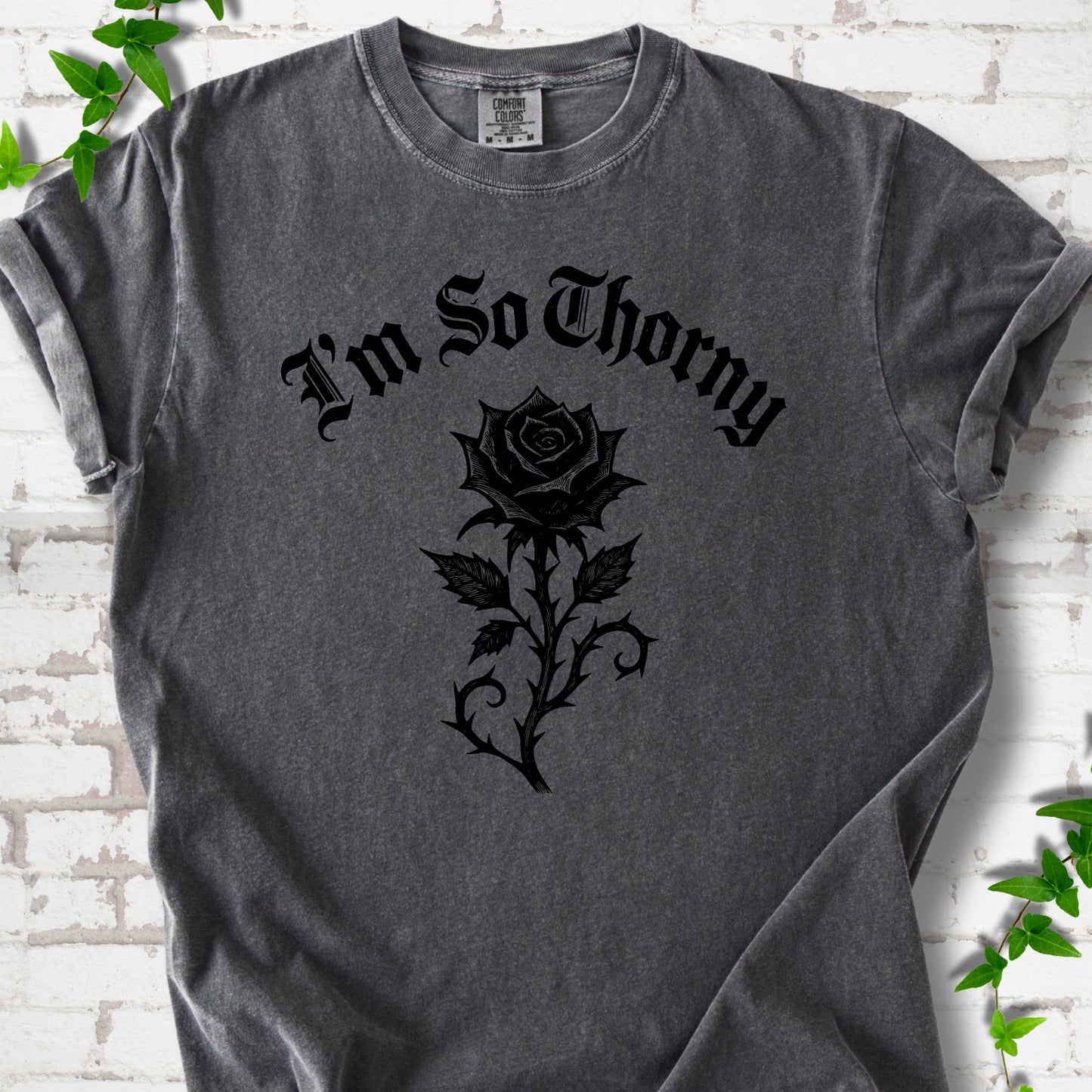 Pepper Comfort Colors® T-shirt flat lay with a distressed Gothic blackletter I'm So Thorny rose design.