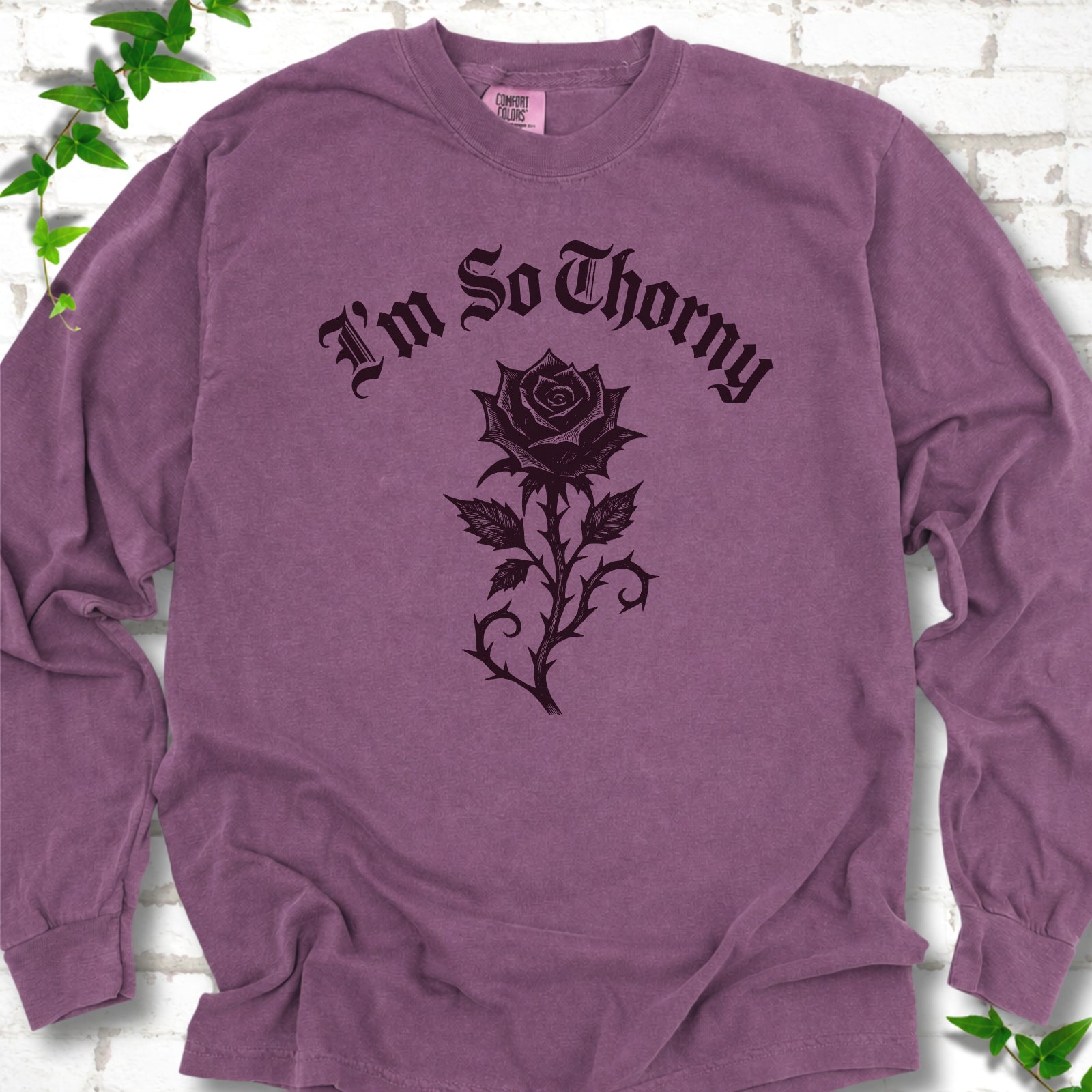 Berry Comfort Colors® long sleeve T-shirt flat lay with a distressed Gothic blackletter I'm So Thorny rose design.