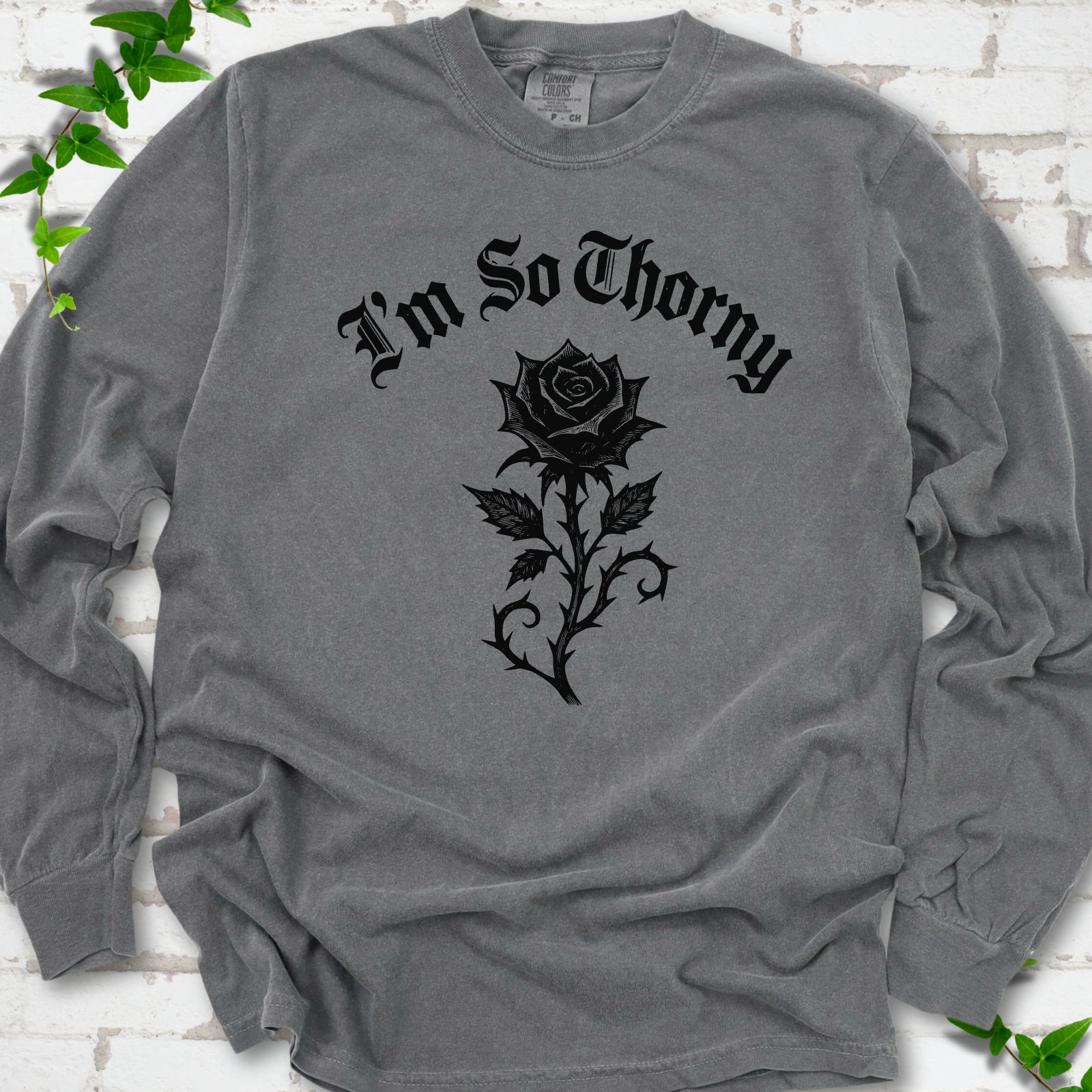 Pepper Comfort Colors® long sleeve T-shirt flat lay with a distressed Gothic blackletter I'm So Thorny rose design.