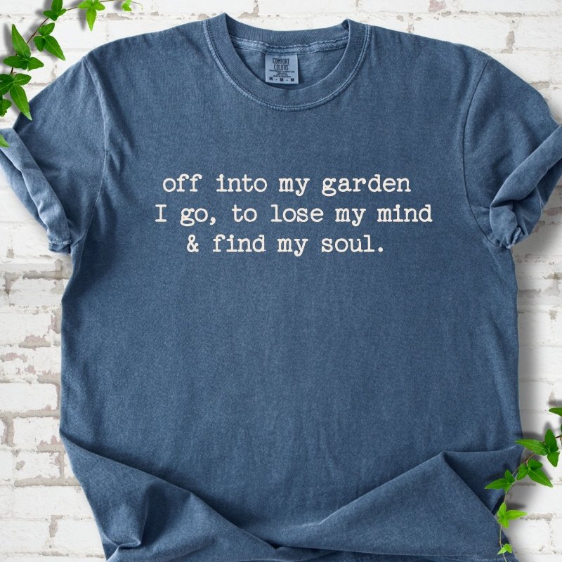 Denim Comfort Colors® short sleeve T-shirt flat lay with white text reading "Off into my garden I go, to lose my mind and find my soul"