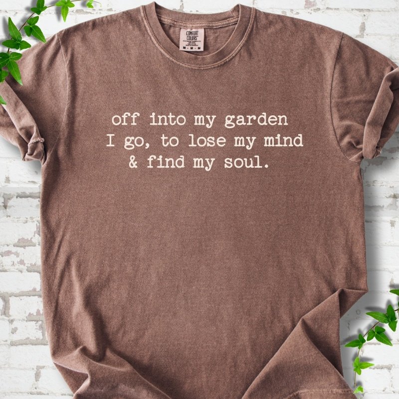 Espresso Comfort Colors® short sleeve T-shirt flat lay with white text reading "Off into my garden I go, to lose my mind and find my soul"