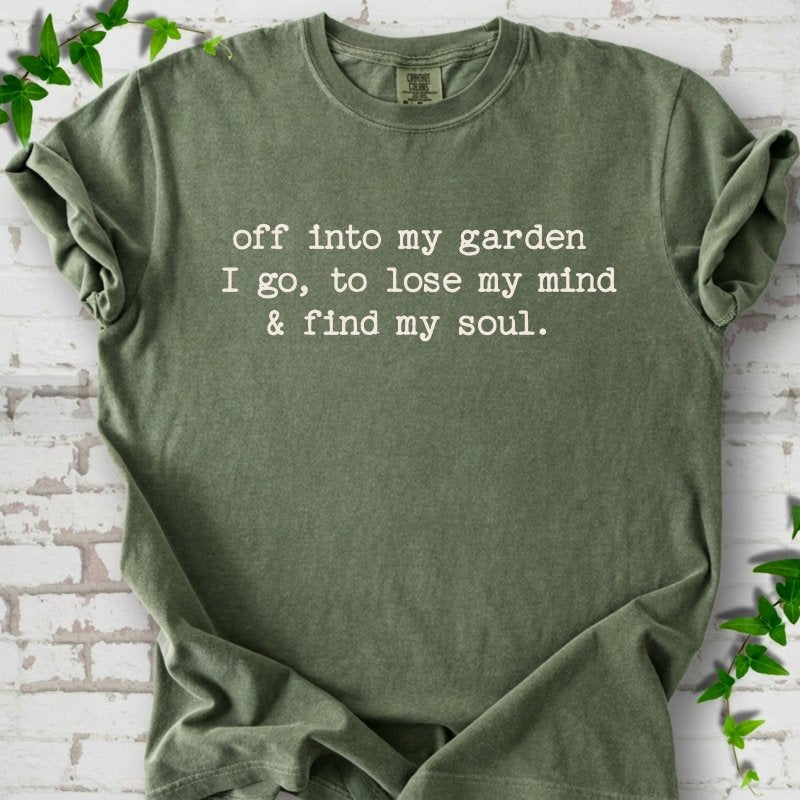 Moss Comfort Colors® short sleeve T-shirt flat lay with white text reading "Off into my garden I go, to lose my mind and find my soul"