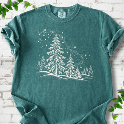 Blue Spruce Comfort Colors T-shirt flat lay with white snow-covered spruce and pine forest design