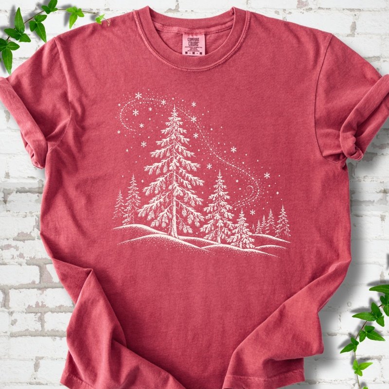 Crimson Comfort Colors T-shirt flat lay with white snow-covered spruce and pine forest design