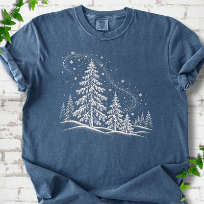 Denim Comfort Colors T-shirt flat lay with white snow-covered spruce and pine forest design