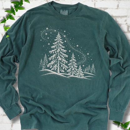 Blue Spruce Comfort Colors long sleeve T-shirt flat lay with white snow-covered spruce and pine forest design
