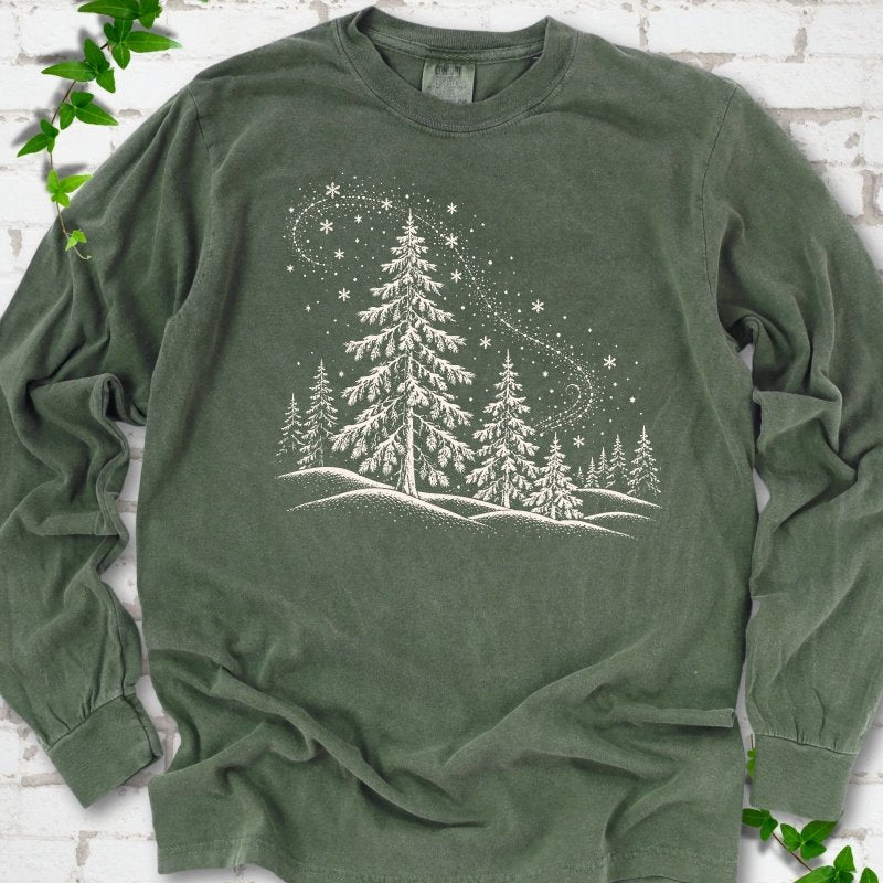 Hemp Comfort Colors long sleeve T-shirt flat lay with white snow-covered spruce and pine forest design