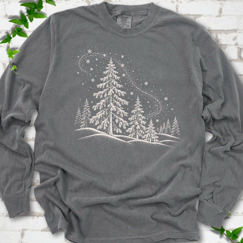 Pepper Comfort Colors long sleeve T-shirt flat lay with white snow-covered spruce and pine forest design