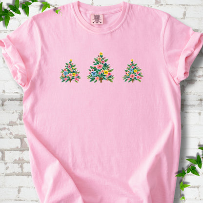 Blossom short-sleeve T-shirt laid flat on white brick with three flower-filled trees centered on the front.