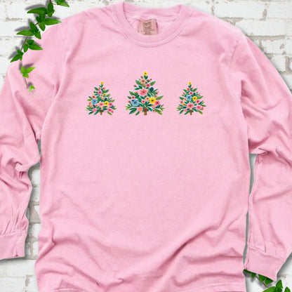 Blossom long-sleeve T-shirt laid flat on white brick with three flower-filled trees centered on the front.