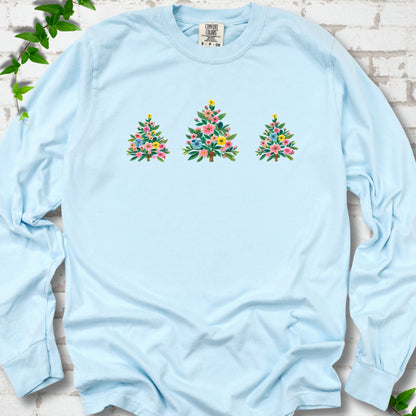 Chambray long-sleeve T-shirt laid flat on white brick with three flower-filled trees centered on the front.