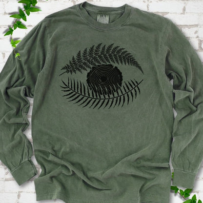 Hemp Comfort Colors® long sleeve T-shirt flat lay featuring a black botanical eye formed by fern fronds and a tree-ring centre.