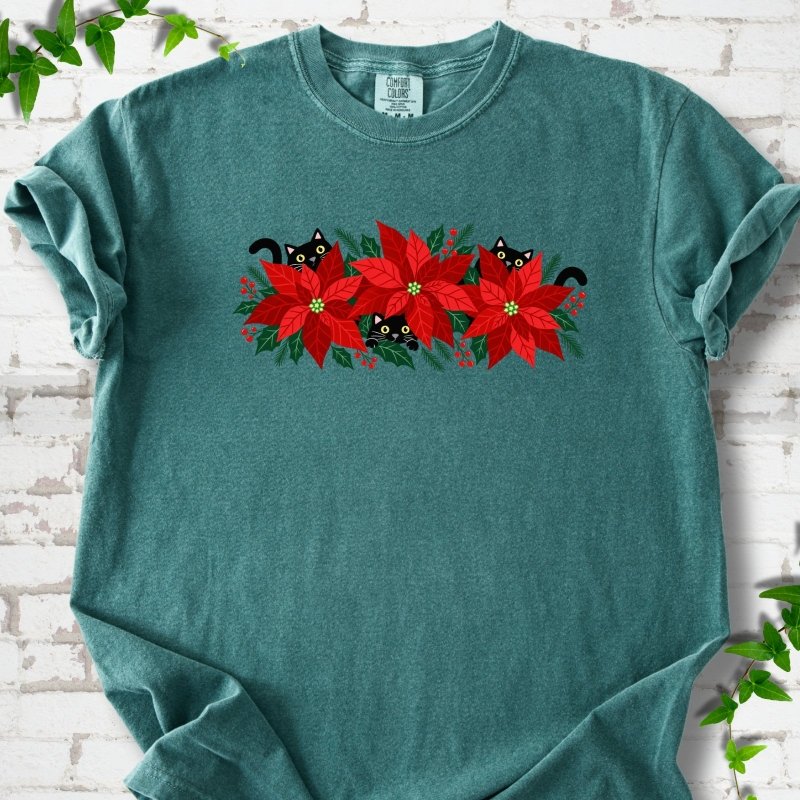 Blue Spruce Comfort Colors® T-shirt shown flat with black cats peeking through red poinsettias and holiday greenery