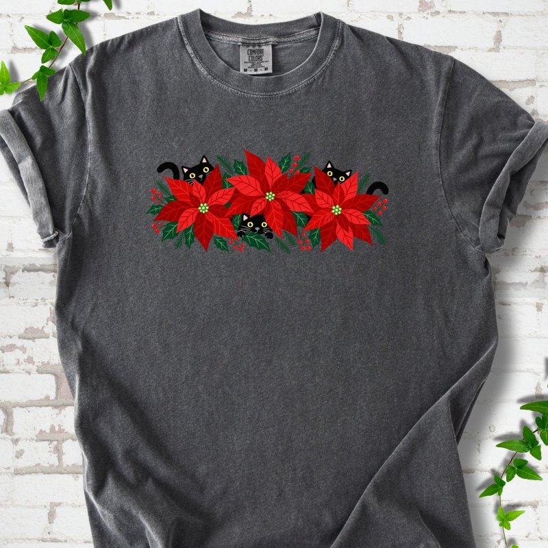 Pepper Comfort Colors® T-shirt shown flat with black cats peeking through red poinsettias and holiday greenery