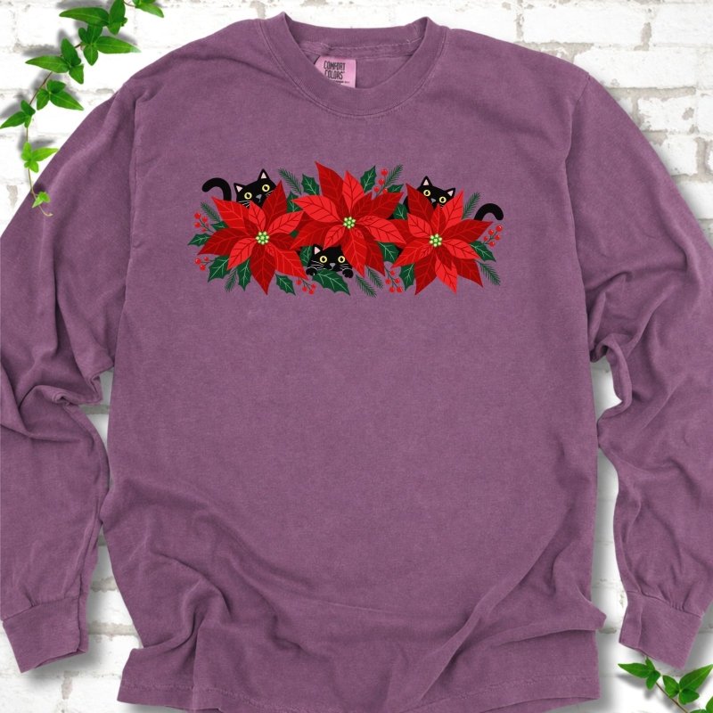 Berry Comfort Colors® long sleeve T-shirt shown flat with black cats peeking through red poinsettias and holiday greenery