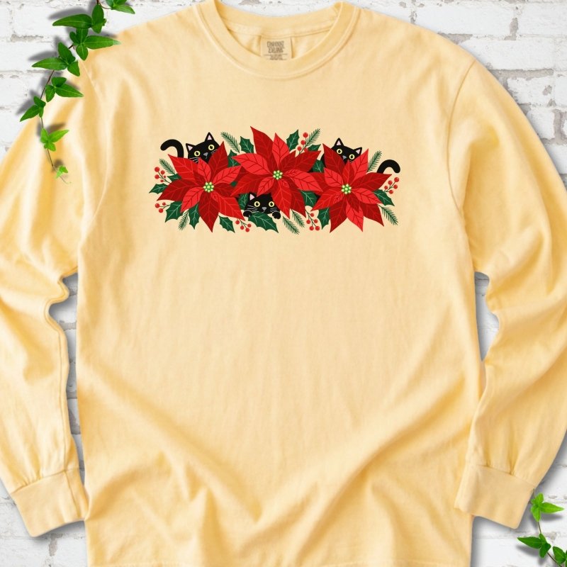 Butter Comfort Colors® long sleeve T-shirt shown flat with black cats peeking through red poinsettias and holiday greenery