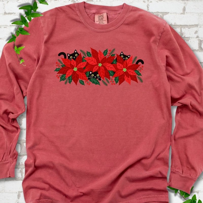 Crimson Comfort Colors® long sleeve T-shirt shown flat with black cats peeking through red poinsettias and holiday greenery