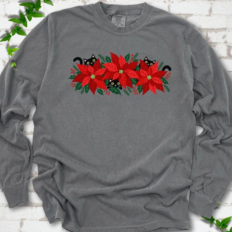 Pepper Comfort Colors® long sleeve T-shirt shown flat with black cats peeking through red poinsettias and holiday greenery