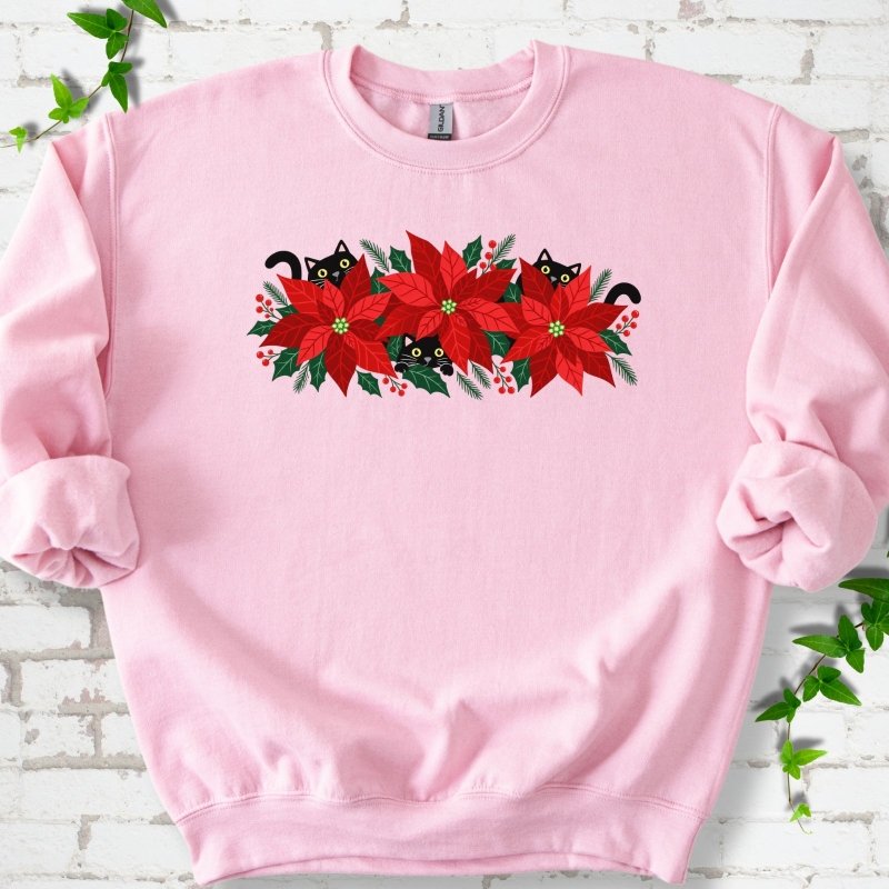 Light Pink classic sweatshirt shown flat with black cats peeking through red poinsettias and holiday greenery