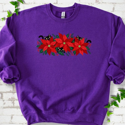 Purple classic sweatshirt shown flat with black cats peeking through red poinsettias and holiday greenery