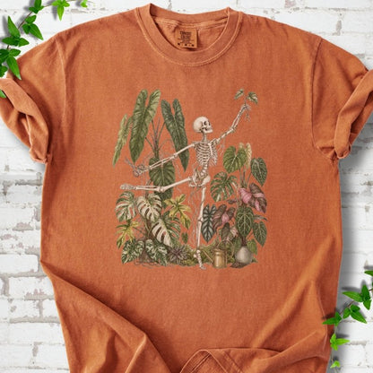 Yam Comfort Colors® T-shirt front mockup featuring a skeleton tending a collection of leafy houseplants.