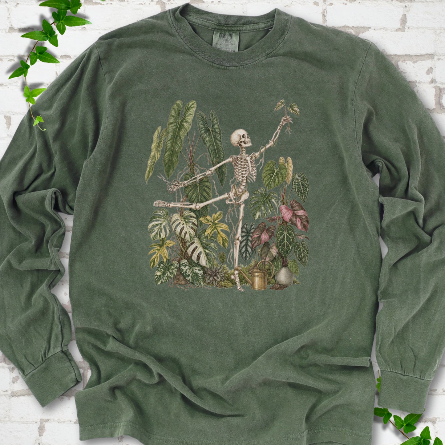 Hemp Comfort Colors® long sleeve T-shirt front mockup featuring a skeleton tending a collection of leafy houseplants.
