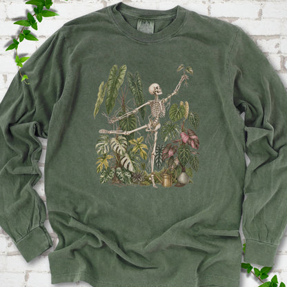 Hemp Comfort Colors® long sleeve T-shirt front mockup featuring a skeleton tending a collection of leafy houseplants.