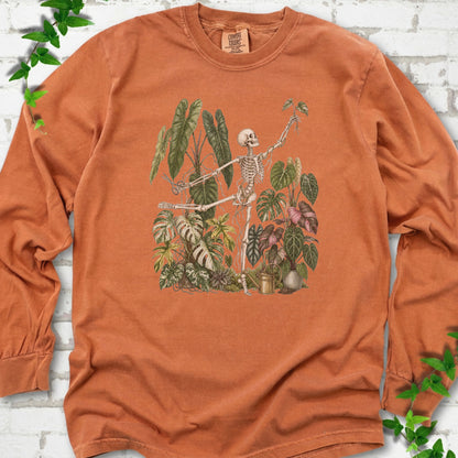 Yam Comfort Colors® long sleeve T-shirt front mockup featuring a skeleton tending a collection of leafy houseplants.