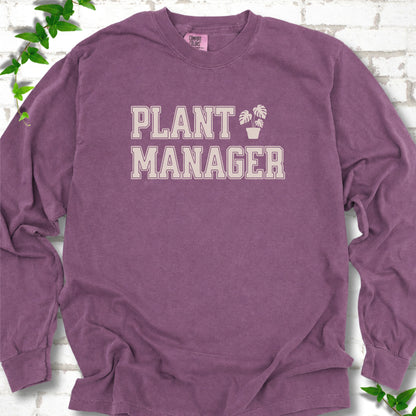 Berry Comfort Colors® long sleeve T-shirt front mockup featuring the collegiate Plant Manager design with a potted monstera.