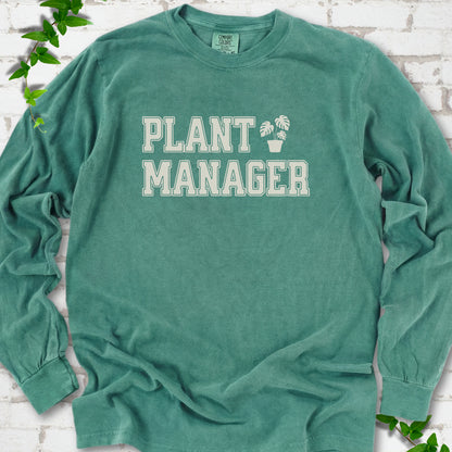 Light Green Comfort Colors® long sleeve T-shirt front mockup featuring the collegiate Plant Manager design with a potted monstera.