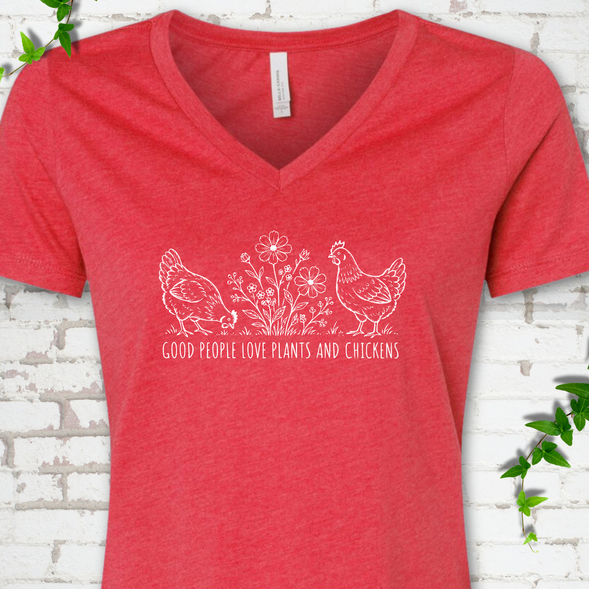 Heather Red women's V-neck T-shirt flat lay with white line-art hens and flowers above the words "Good People Love Plants and Chickens."