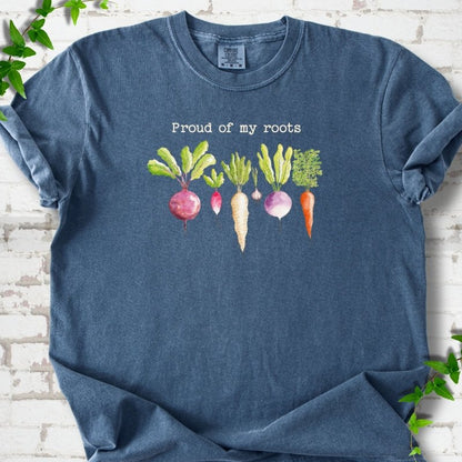 Denim Comfort Colors® T-shirt shown flat with "Proud of My Roots" text above watercolor-style root vegetables