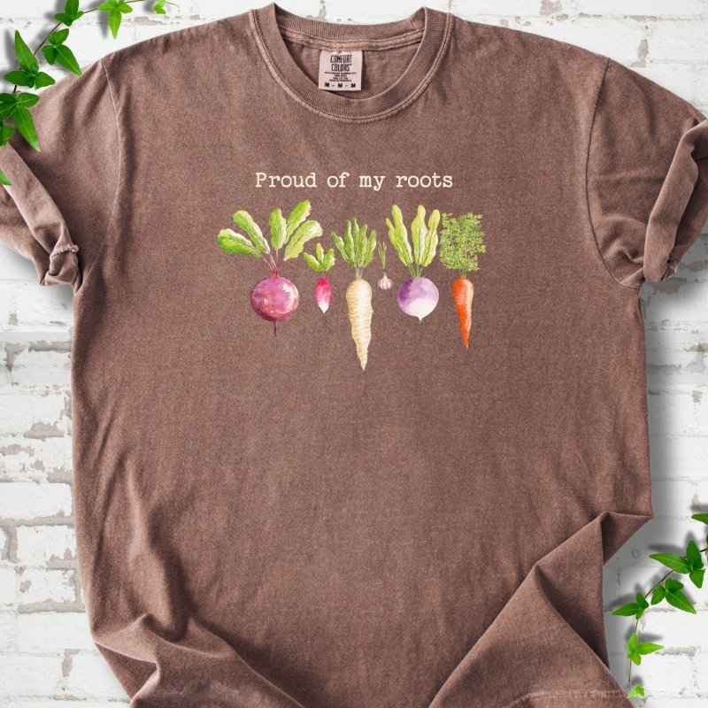 Espresso Comfort Colors® T-shirt shown flat with "Proud of My Roots" text above watercolor-style root vegetables