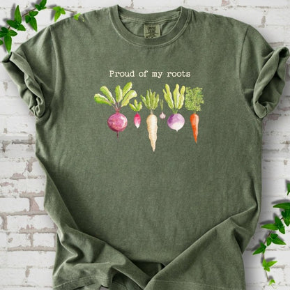 Moss Comfort Colors® T-shirt shown flat with "Proud of My Roots" text above watercolor-style root vegetables