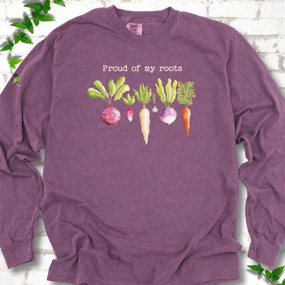 Berry Comfort Colors® long sleeve T-shirt shown flat with "Proud of My Roots" text above watercolor-style root vegetables