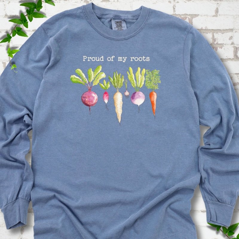 Blue Jean Comfort Colors® long sleeve T-shirt shown flat with "Proud of My Roots" text above watercolor-style root vegetables