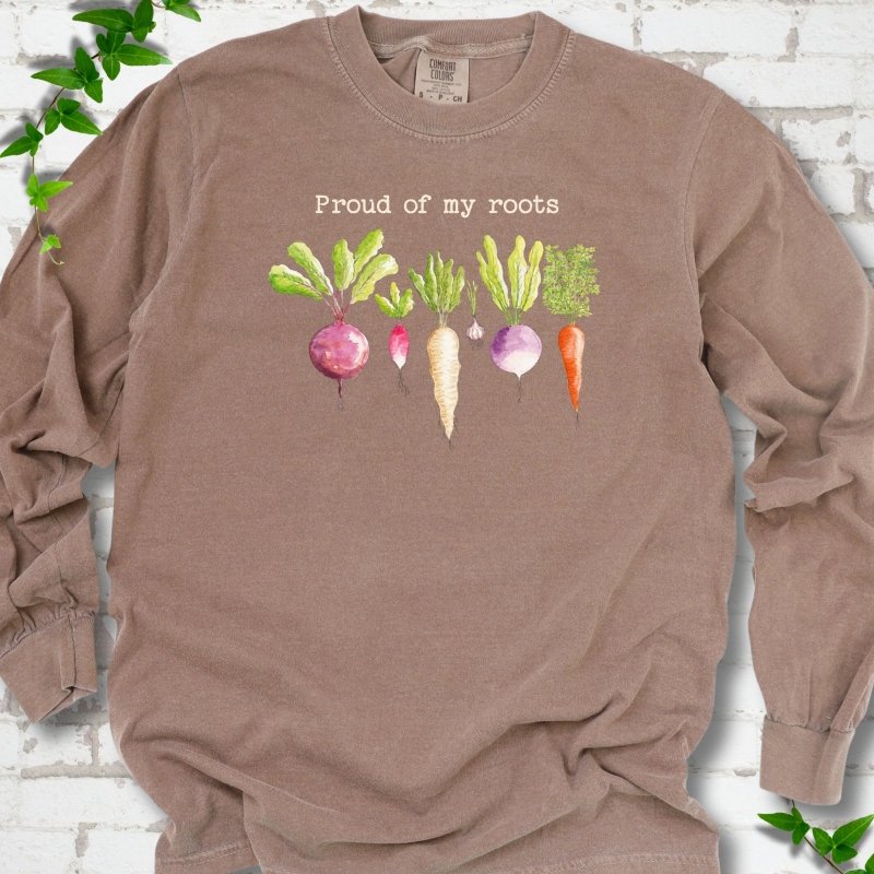 Espresso Comfort Colors® long sleeve T-shirt shown flat with "Proud of My Roots" text above watercolor-style root vegetables