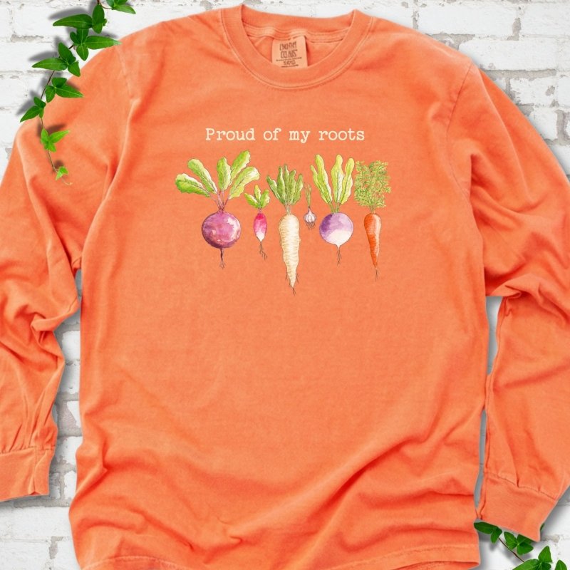 Melon Comfort Colors® long sleeve T-shirt shown flat with "Proud of My Roots" text above watercolor-style root vegetables