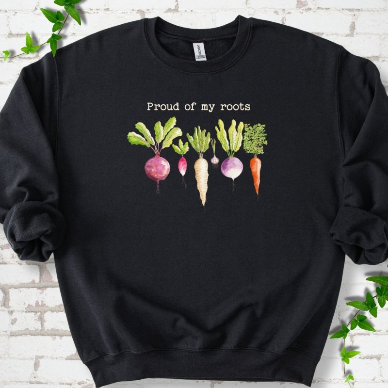Black classic sweatshirt shown flat with "Proud of My Roots" text above watercolor-style root vegetables