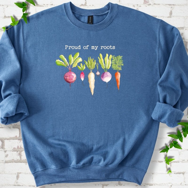Indigo Blue classic sweatshirt shown flat with "Proud of My Roots" text above watercolor-style root vegetables