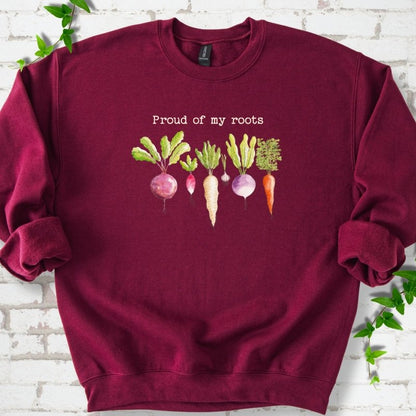 Maroon classic sweatshirt shown flat with "Proud of My Roots" text above watercolor-style root vegetables
